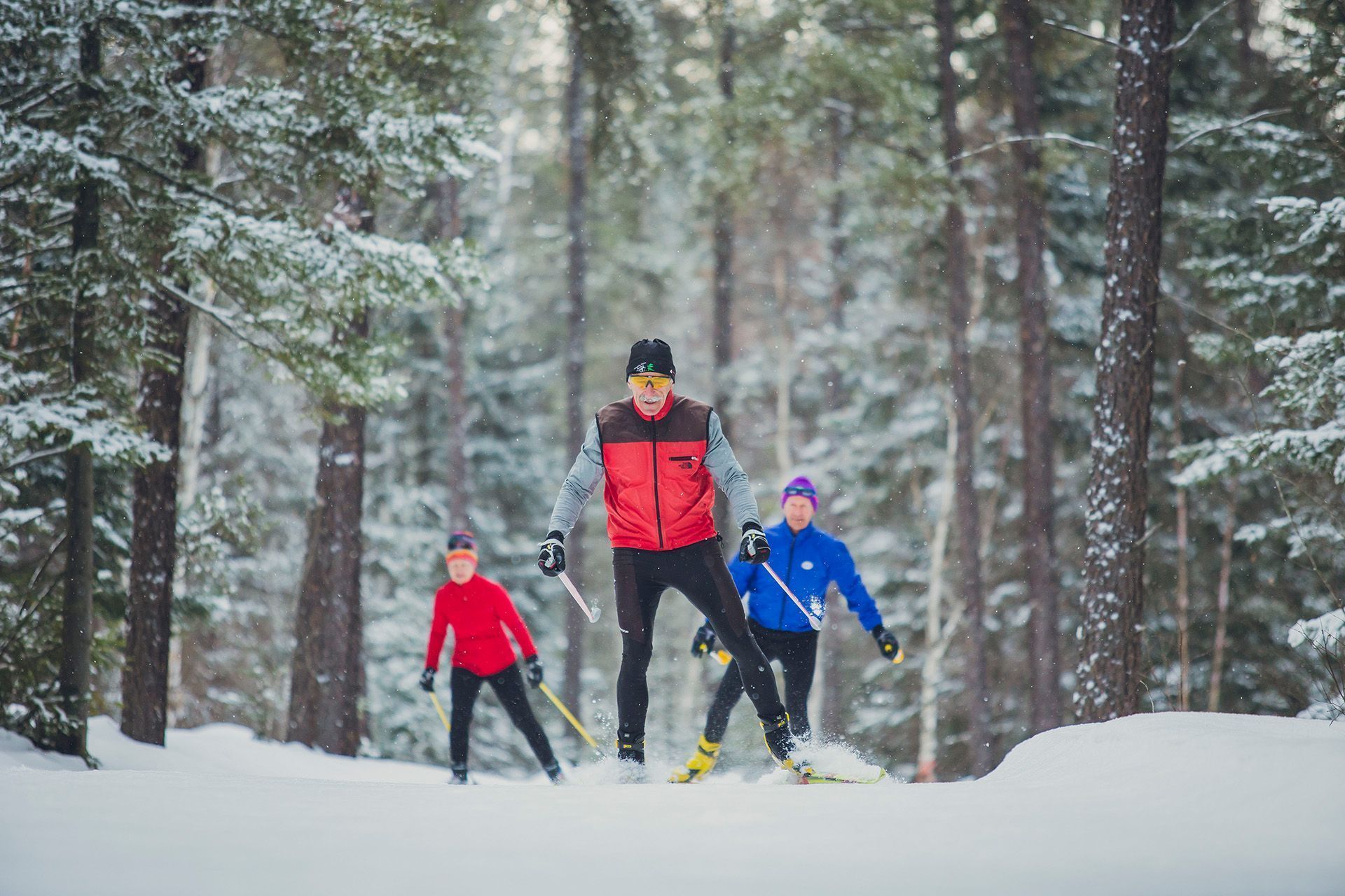 Three people skiing at Onaping Falls Nordics Ski Club.