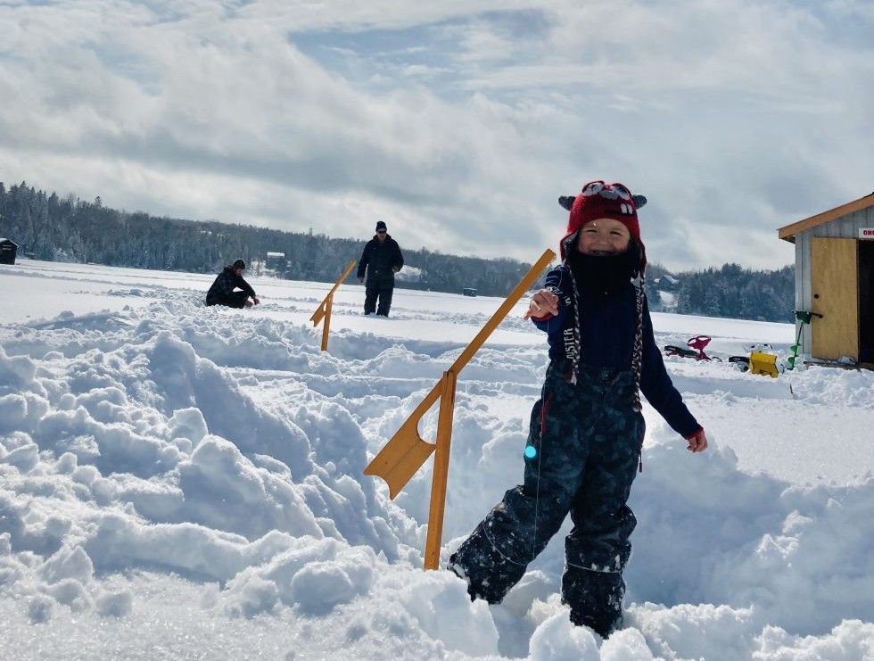 A kid gets ready to ice fish on Nosbonsing lake.